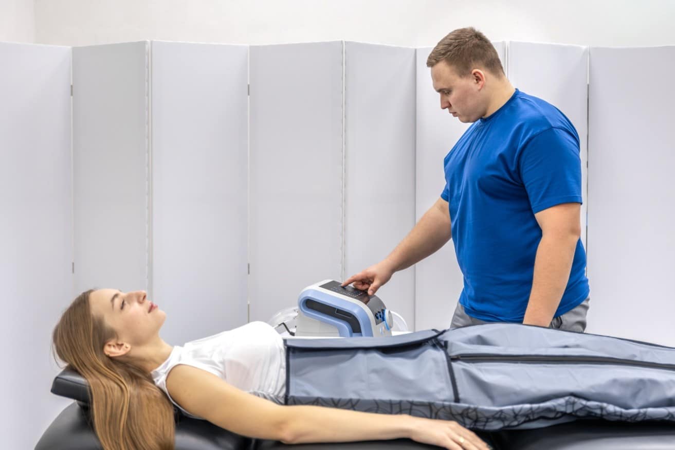 doctor-monitors-pressotherapy-device-with-woman-patient-rehabilitation-care (1) (1) (1) (1)